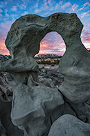 Sunset behind natural arch in Colorado.