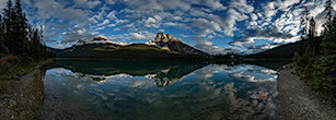 Panaroma of mountains reflected in Emerald Lake.