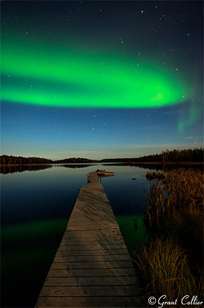 Aurora Borealis over lake in Canada.